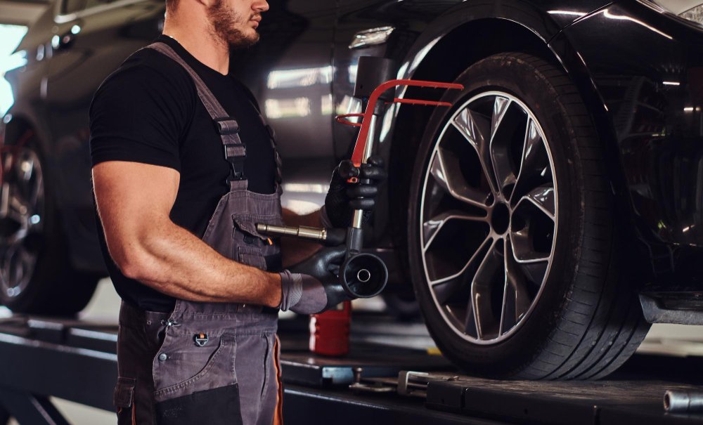 A mechanic doing Wheel Alignment