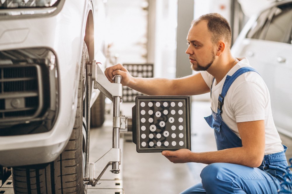 Mechanic doing wheel alignment